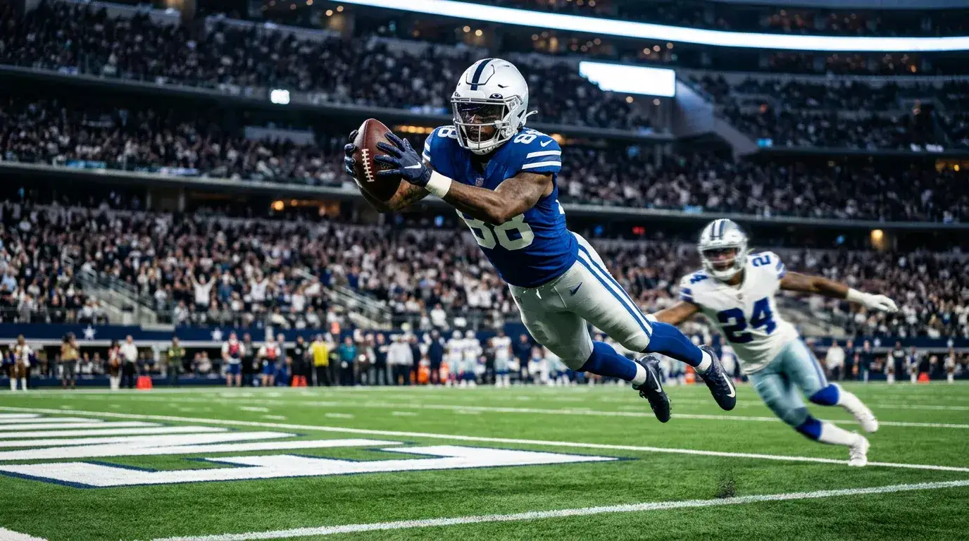 NFL wide receiver catching an American football in mid-air inside the end-zone of a regulation gridiron
